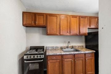 Indianapolis apartment for rent - a small kitchen with a stove and a sink