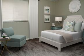 Indianapolis apartment for rent - a bedroom with a bed and a chair and a window