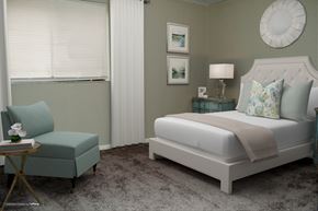 Indianapolis apartment for rent - a bedroom with a bed and a chair and a window