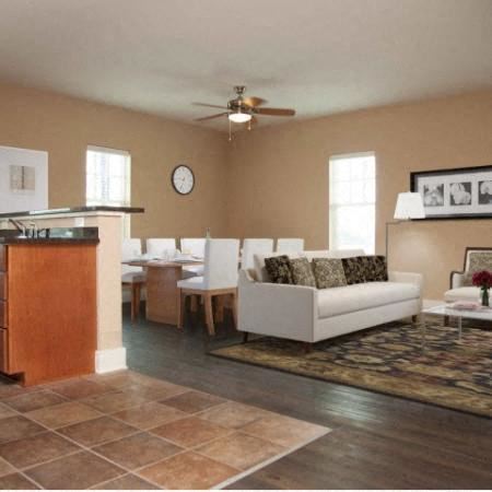 Houma apartment for rent - a living room with a white couch and a dining table
