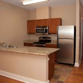 Houma apartment for rent - a kitchen with stainless steel appliances and a marble counter top