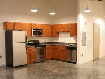 New Orleans apartment for rent - a kitchen with stainless steel appliances and wooden cabinets