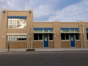 New Orleans apartment for rent - a building with blue doors and windows on a street