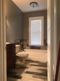 Calhoun house for rent - a bathroom with a toilet and a bath tub