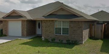 Brownsville house for rent - A house with a grey roof and a white garage door.