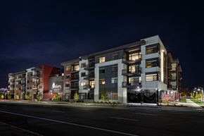 Boise apartment for rent - A modern apartment building with a dark sky in the background.