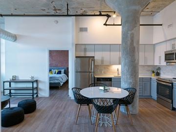 Windsor Locks apartment for rent - A kitchen with a table and chairs in the foreground and a bedroom in the background.
