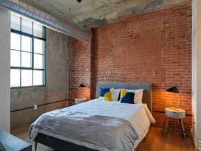 Windsor Locks apartment for rent - Bedroom with Exposed Brick and Concrete at Montgomery Mill Apartments in Windsor Locks, CT