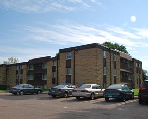Mankato apartment for rent - an apartment building with cars parked in a parking lot