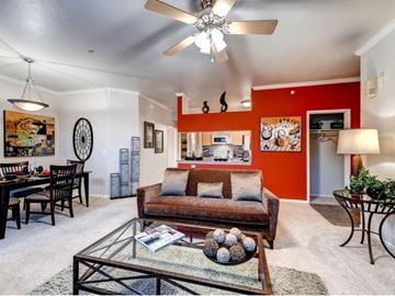 Aurora apartment for rent - A living room with a glass coffee table and a brown couch.