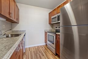 Hummelstown apartment for rent - a kitchen with stainless steel appliances and wooden cabinets