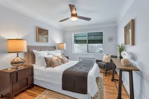 Denver apartment for rent - a bedroom with a bed and a ceiling fan