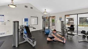 San Marcos apartment for rent - A man is stretching in a gym with a blue exercise ball.