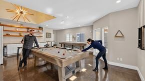 San Marcos apartment for rent - Two people playing pool in a well-lit room.