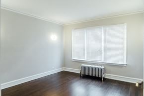 Chicago apartment for rent - an empty room with a radiator and a window