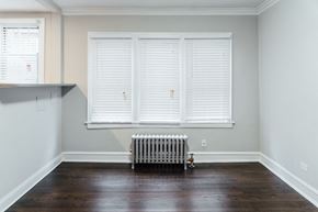 Chicago apartment for rent - a living room with wood floors and a radiator