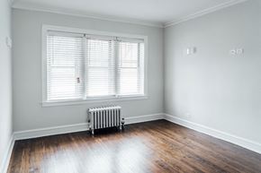 Chicago apartment for rent - a room with wood floors and a radiator and a window