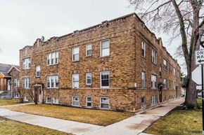 Chicago apartment for rent - an old brick building on the corner of a sidewalk