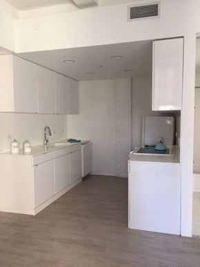Cleveland apartment for rent - an empty kitchen with white cabinets and a sink