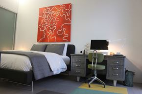 Cleveland apartment for rent - a bedroom with a bed and a desk with a computer