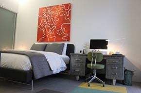 Cleveland apartment for rent - a bedroom with a bed and a desk with a computer