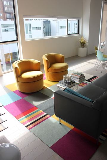 Cleveland apartment for rent - a living room with yellow chairs and a colorful rug