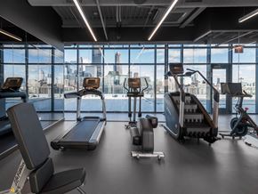 Chicago apartment for rent - a gym with cardio equipment and a view of the city