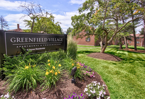 Rocky Hill apartment for rent - A sign that says Greenfield Village stands in front of a building.