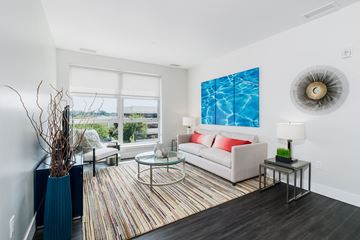 Fairfield apartment for rent - A living room with a couch, a table, and a painting on the wall.