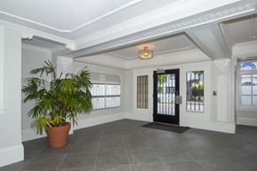 San Francisco apartment for rent - A room with a potted plant, a black door, and a chandelier.