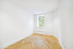 Brooklyn apartment for rent - a room with white walls and a window and wooden floors