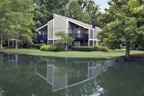 Memphis apartment for rent - A house with a grey roof and a balcony is reflected in the water.