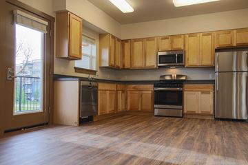 Missoula apartment for rent - a kitchen with wooden cabinets and stainless steel appliances