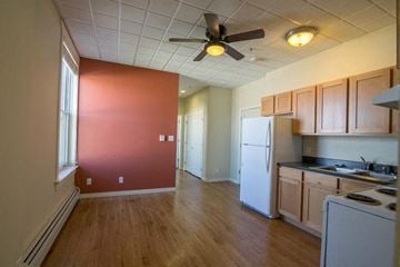 Missoula apartment for rent - a kitchen with a white refrigerator and a ceiling fan