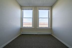 Missoula apartment for rent - an empty room with three windows and a carpet