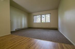 Missoula apartment for rent - an empty living room with a wooden floor and a window
