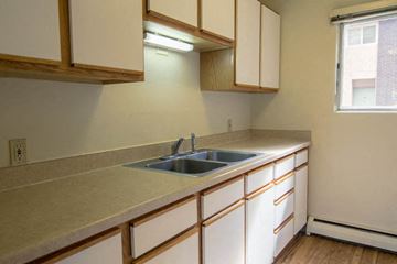 Missoula apartment for rent - a kitchen with a sink and cabinets and a window