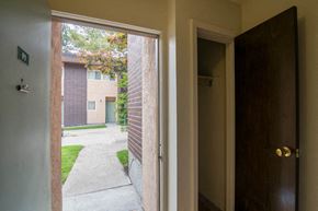 Missoula apartment for rent - an open door with a view of a yard and a building