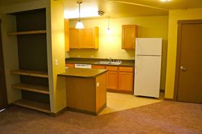 Missoula apartment for rent - an empty kitchen with a white refrigerator and cabinets