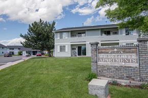 Missoula apartment for rent - an apartment building with a sign in the grass