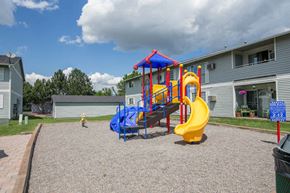 Missoula apartment for rent - a playground in a yard with a blue and yellow swing set