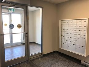Portage La Prairie apartment for rent - a locker room with a door and some mailboxes on the wall