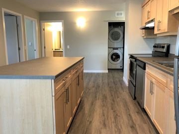Portage La Prairie apartment for rent - a kitchen with a counter top and a washer and dryer in it
