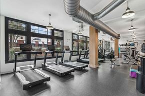 Chamblee apartment for rent - a gym with treadmills and other exercise equipment and windows