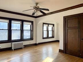Milwaukee apartment for rent - a living room with a ceiling fan and a wood floor