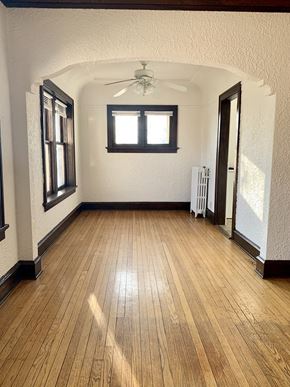 Milwaukee apartment for rent - a living room with a hard wood floor and a ceiling fan