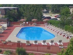 New Berlin apartment for rent - an aerial view of a swimming pool with chairs around it
