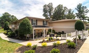 Greensboro apartment for rent - A building with a white picket fence in front of it.