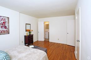 Lancaster apartment for rent - a bedroom with white walls and wood floors and a bed