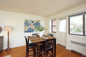 Lancaster apartment for rent - a dining room with a wooden table and chairs and a window